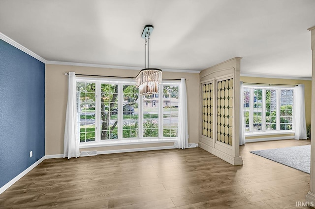 3111 N Eastlake Dr, Elkhart, IN 46514 - unfurnished dining area featuring ornamental molding, plenty of natural light, and wood finished floors