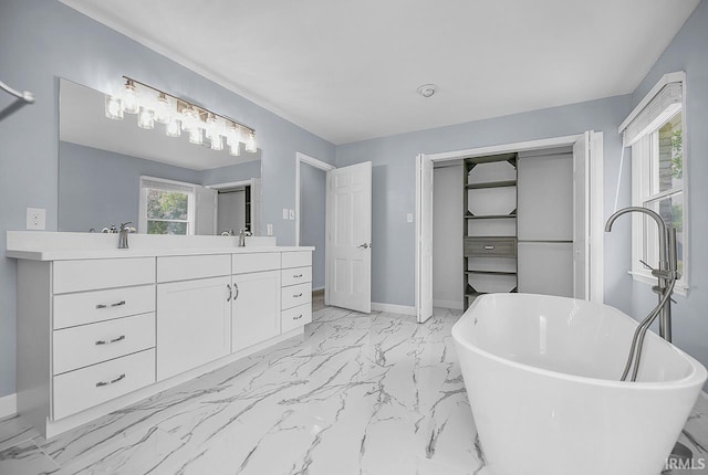 3111 N Eastlake Dr, Elkhart, IN 46514 - bathroom with double vanity, a soaking tub, and marble look tile flooring