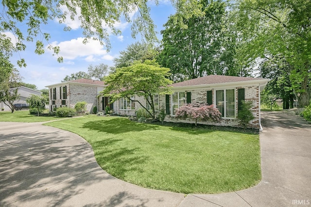 3111 N Eastlake Dr, Elkhart, IN 46514 - view of front of house with a front lawn, concrete driveway, and brick siding