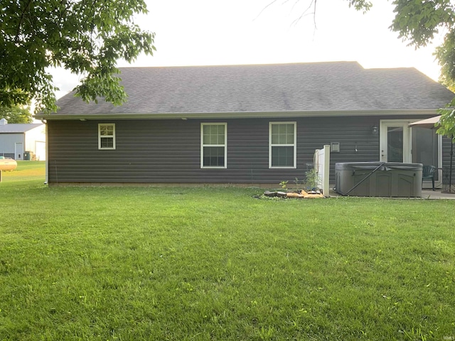 6243 S 700 W, West Point, IN 47992 - rear view of house featuring a hot tub, a yard, and a shingled roof