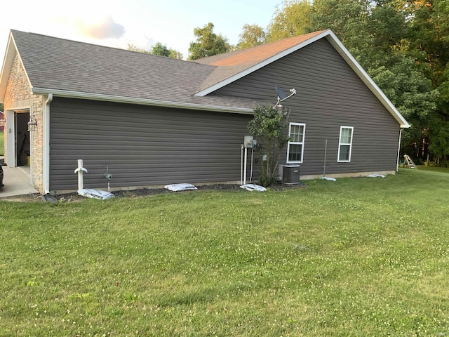 6243 S 700 W, West Point, IN 47992 - back of property with a yard, a shingled roof, and a garage