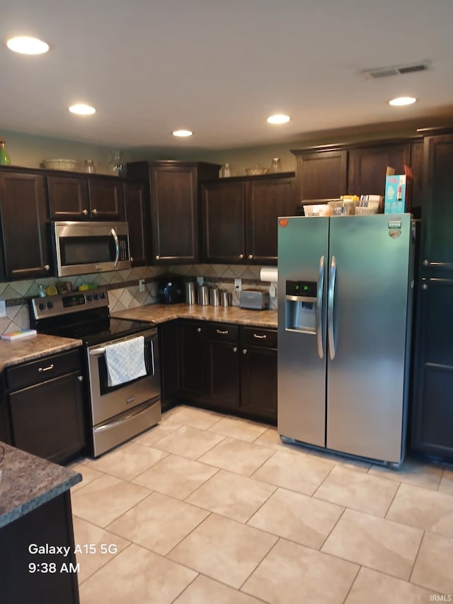 6243 S 700 W, West Point, IN 47992 - kitchen featuring appliances with stainless steel finishes, backsplash, stone countertops, dark brown cabinets, and recessed lighting
