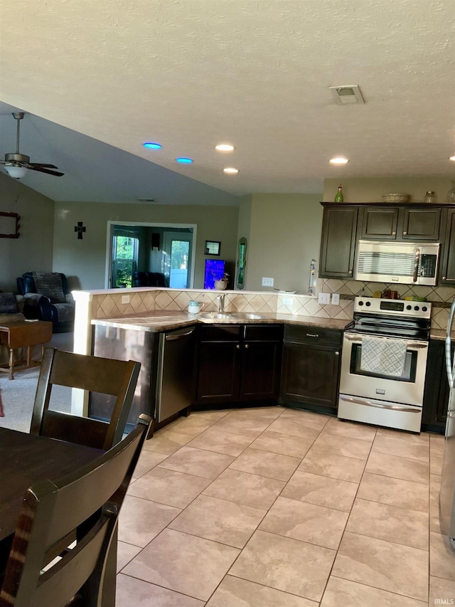 6243 S 700 W, West Point, IN 47992 - kitchen with stainless steel appliances, backsplash, open floor plan, ceiling fan, and recessed lighting
