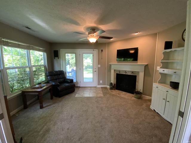 6243 S 700 W, West Point, IN 47992 - carpeted living area with a fireplace, a ceiling fan, a textured ceiling, and tile patterned flooring