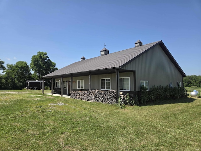 5811W Janssen Ln, Crawfordsville, IN 47933 - back of house featuring a yard, a metal roof, and a chimney