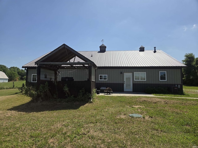 5811W Janssen Ln, Crawfordsville, IN 47933 - rear view of house with a lawn, a patio, and a metal roof