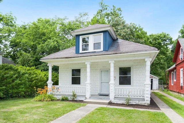 3222 Dinnen Ave, Fort Wayne, IN 46807 - view of front of house with covered porch, a front yard, and roof with shingles