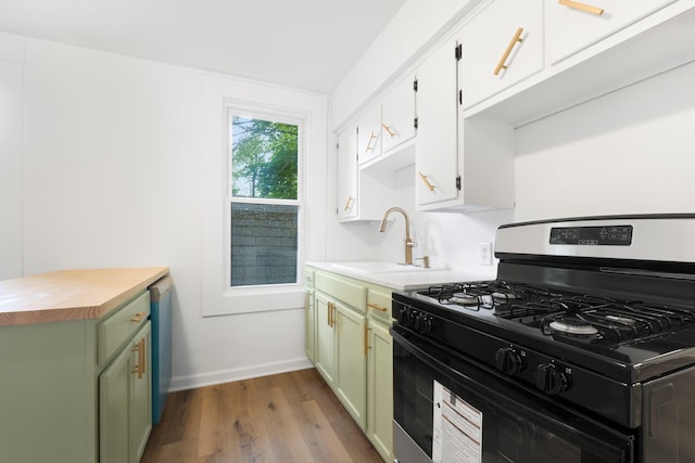 3222 Dinnen Ave, Fort Wayne, IN 46807 - kitchen featuring black gas stove, butcher block counters, dark wood-style flooring, green cabinets, and white cabinets