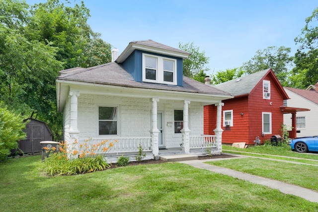 3222 Dinnen Ave, Fort Wayne, IN 46807 - bungalow-style home featuring a chimney, a porch, a storage unit, a front yard, and a shingled roof