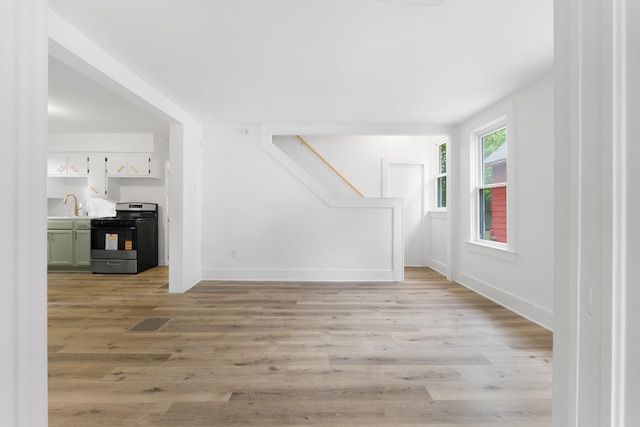 3222 Dinnen Ave, Fort Wayne, IN 46807 - unfurnished living room with light wood-style floors and stairs