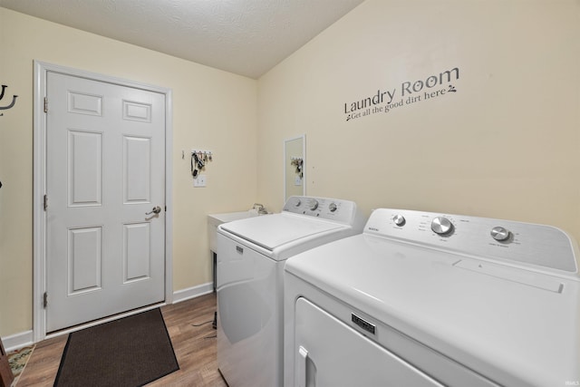 378 Buchanan St, West Lafayette, IN 47906 - laundry area with washer and dryer, wood finished floors, and a textured ceiling
