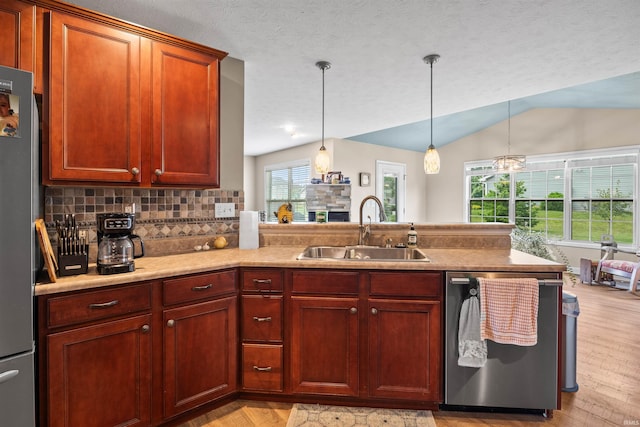 378 Buchanan St, West Lafayette, IN 47906 - kitchen featuring appliances with stainless steel finishes, a peninsula, light wood-style floors, lofted ceiling, and hanging light fixtures