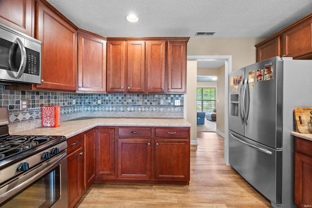 378 Buchanan St, West Lafayette, IN 47906 - kitchen with stainless steel appliances, light wood-type flooring, and tasteful backsplash