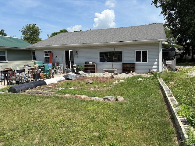 rear view of house with a lawn and a patio area