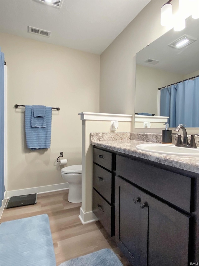 3065 E Butler Ct, Columbia City, IN 46725 - full bathroom featuring wood finished floors, vanity, and curtained shower