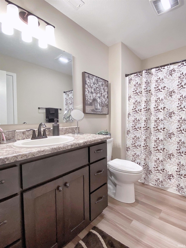 3065 E Butler Ct, Columbia City, IN 46725 - full bath featuring wood finished floors, vanity, and curtained shower
