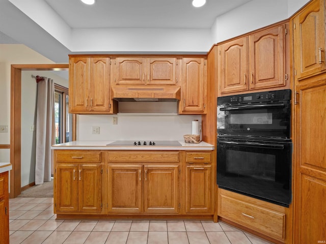 1031 Skyline Pass, Fort Wayne, IN 46825 - kitchen with black appliances, custom range hood, light countertops, light tile patterned flooring, and brown cabinets