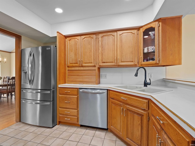 1031 Skyline Pass, Fort Wayne, IN 46825 - kitchen with appliances with stainless steel finishes, light countertops, light tile patterned floors, glass insert cabinets, and brown cabinetry