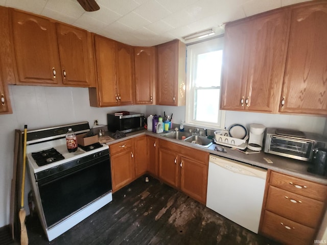 1110 Cummings St, Logansport, IN 46947 - kitchen featuring white dishwasher, gas range oven, stainless steel microwave, dark wood-style floors, and brown cabinetry