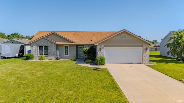 12 Chrysler Ave, Wabash, IN 46992 - ranch-style house featuring an attached garage, a front yard, driveway, and brick siding