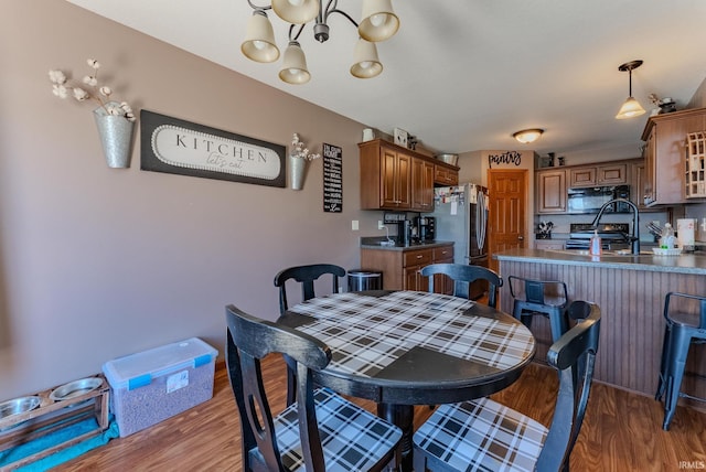 12 Chrysler Ave, Wabash, IN 46992 - dining area featuring light wood-style flooring and a chandelier