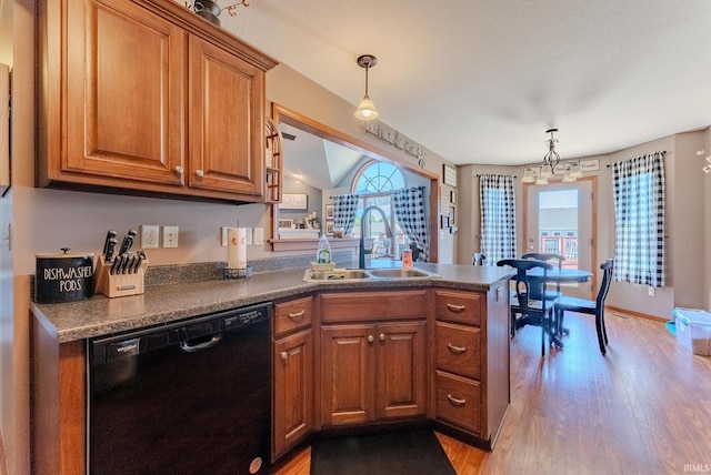 12 Chrysler Ave, Wabash, IN 46992 - kitchen with black dishwasher, brown cabinets, a peninsula, light wood-type flooring, and dark countertops