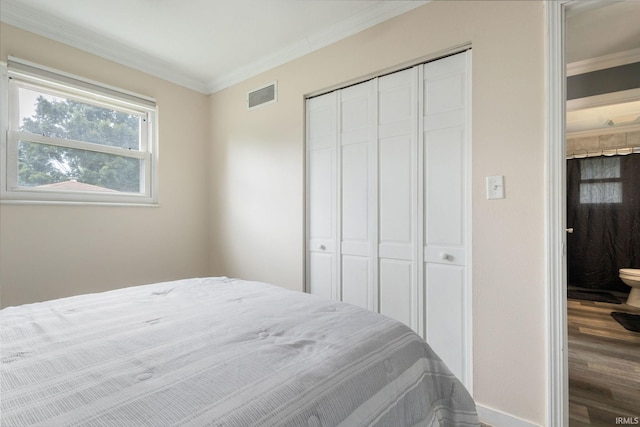 2721 Schumacher Dr, Mishawaka, IN 46545 - bedroom with a closet, crown molding, and wood finished floors