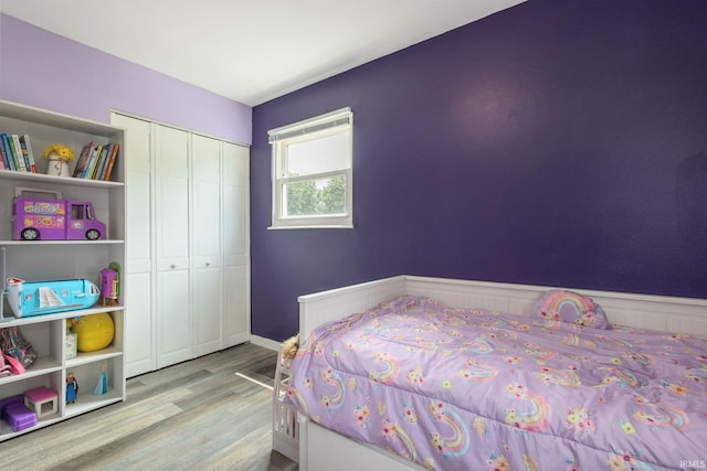 2721 Schumacher Dr, Mishawaka, IN 46545 - bedroom with wood finished floors, a closet, and a wainscoted wall