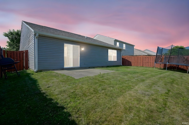 274 Chapelhill Dr, Lafayette, IN 47905 - back of property with a trampoline, a fenced backyard, a patio, and roof with shingles