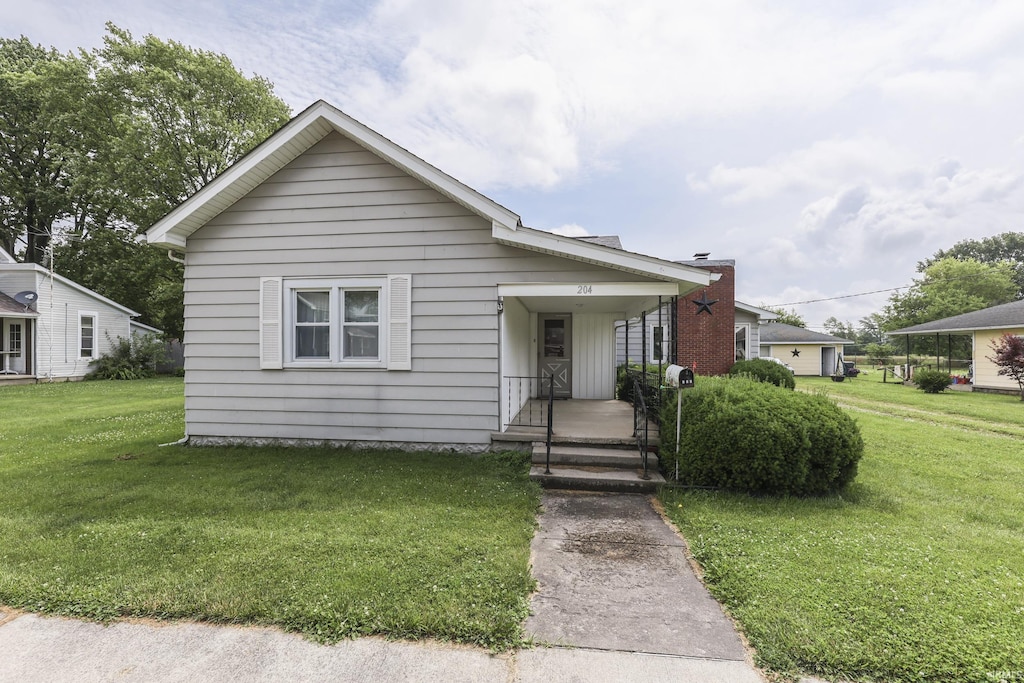 204 N Main St, Kennard, IN 47351 - bungalow featuring a front lawn