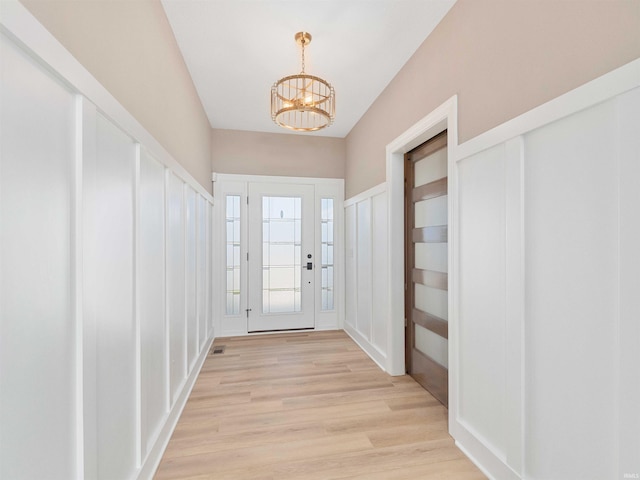 13092 Hallux Cv, Fort Wayne, IN 46845 - doorway to outside featuring a chandelier and light wood finished floors