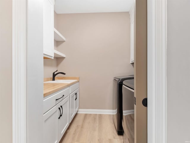 13092 Hallux Cv, Fort Wayne, IN 46845 - washroom with cabinet space, separate washer and dryer, and light wood-style flooring