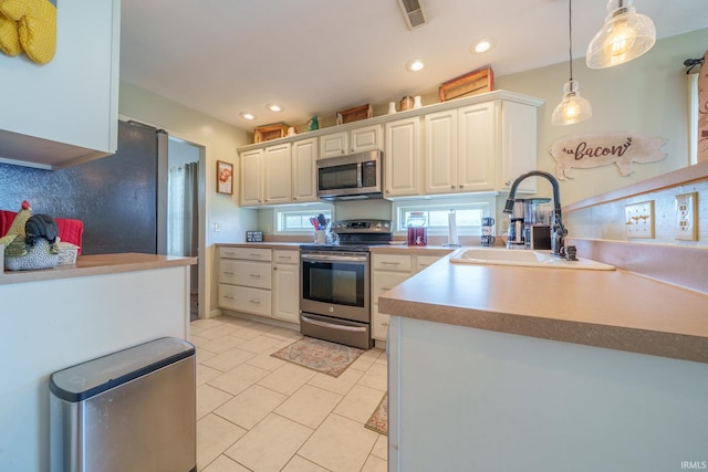 1510 W Crane Pond Dr, Marion, IN 46952 - kitchen featuring appliances with stainless steel finishes, pendant lighting, light tile patterned floors, recessed lighting, and white cabinets