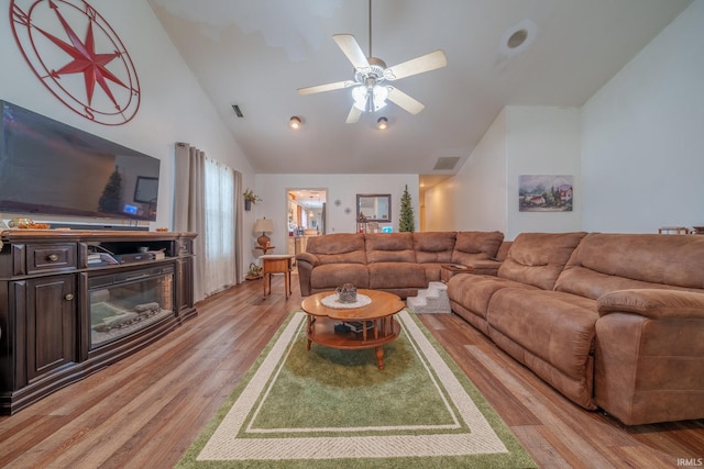 1510 W Crane Pond Dr, Marion, IN 46952 - living area featuring light wood-style floors, a glass covered fireplace, a ceiling fan, and high vaulted ceiling
