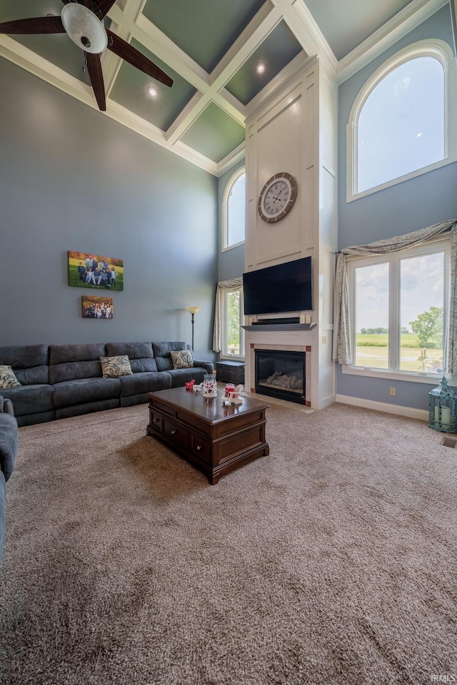 2220 Meadowbrook Dr, Marion, IN 46952 - carpeted living area with a towering ceiling, coffered ceiling, a large fireplace, ceiling fan, and ornamental molding