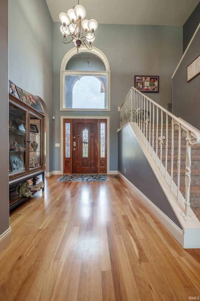 2220 Meadowbrook Dr, Marion, IN 46952 - foyer entrance with a high ceiling, a chandelier, stairway, and wood finished floors