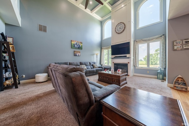 2220 Meadowbrook Dr, Marion, IN 46952 - living area with a high ceiling, coffered ceiling, carpet, a glass covered fireplace, and beam ceiling