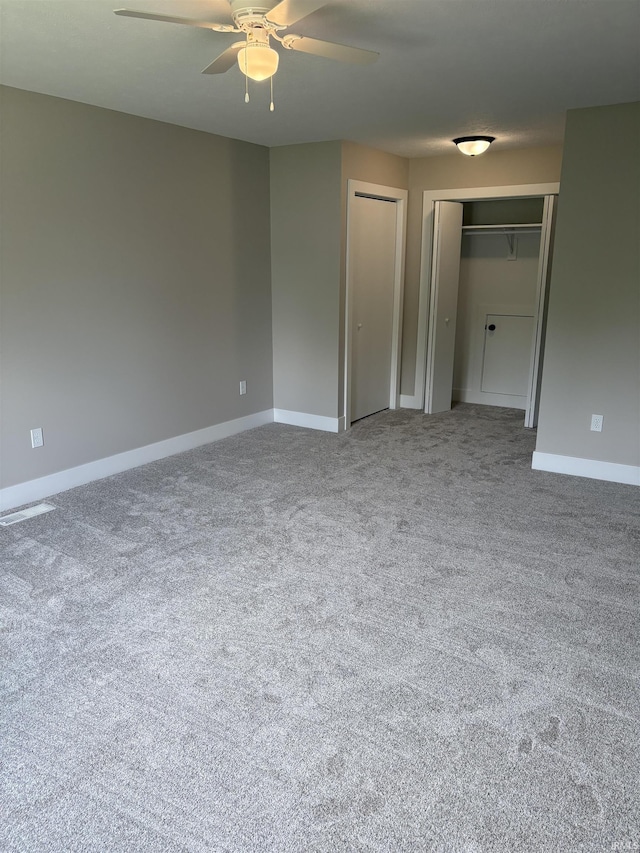 15483 Carriage Ln, Mishawaka, IN 46545 - unfurnished bedroom featuring two closets, carpet, and a ceiling fan