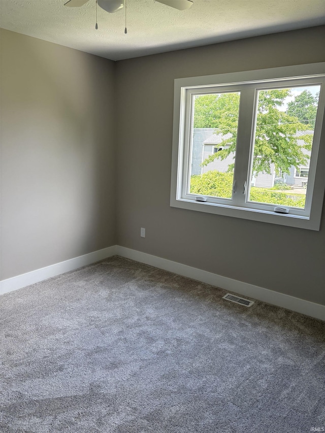 15483 Carriage Ln, Mishawaka, IN 46545 - empty room featuring carpet flooring, ceiling fan, and a textured ceiling