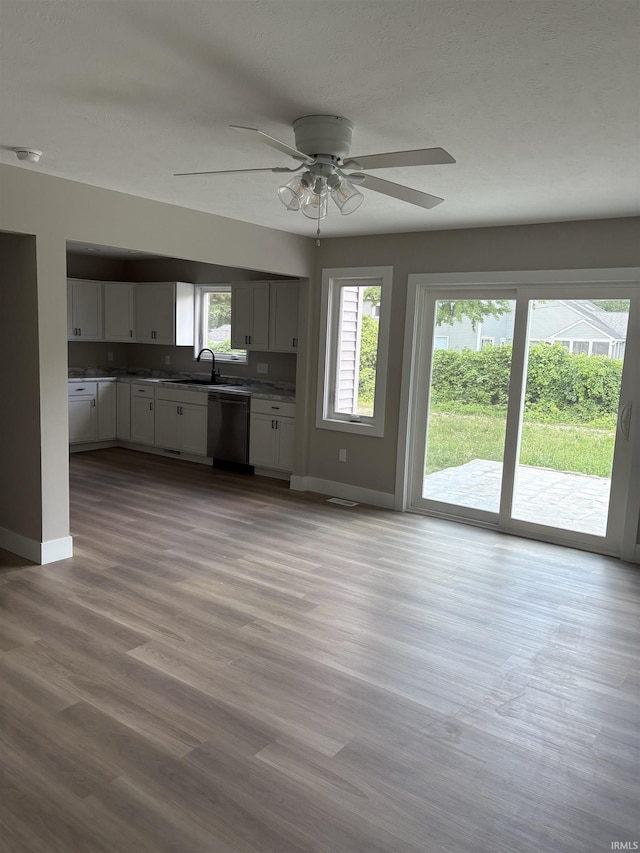 15483 Carriage Ln, Mishawaka, IN 46545 - kitchen with dishwasher, plenty of natural light, and white cabinets