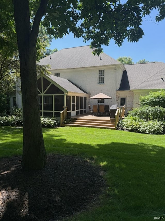 51310 Hidden Pines Ct, Granger, IN 46530 - back of house featuring a sunroom, a deck, a yard, and roof with shingles