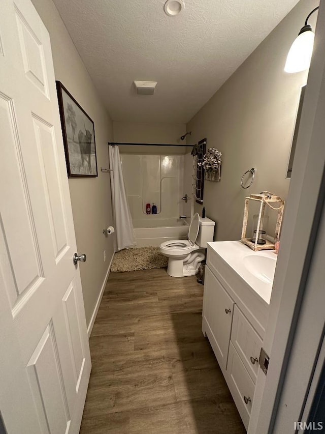 148 SW 8th St, Linton, IN 47441 - bathroom with a textured ceiling, shower / bath combo with shower curtain, vanity, and wood finished floors