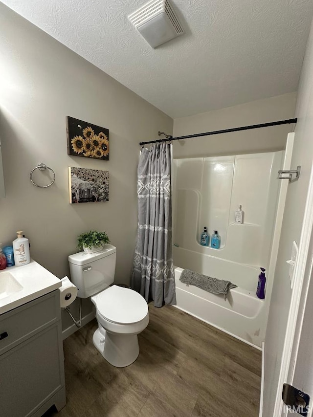 148 SW 8th St, Linton, IN 47441 - full bathroom featuring shower / bathtub combination with curtain, wood finished floors, vanity, and a textured ceiling