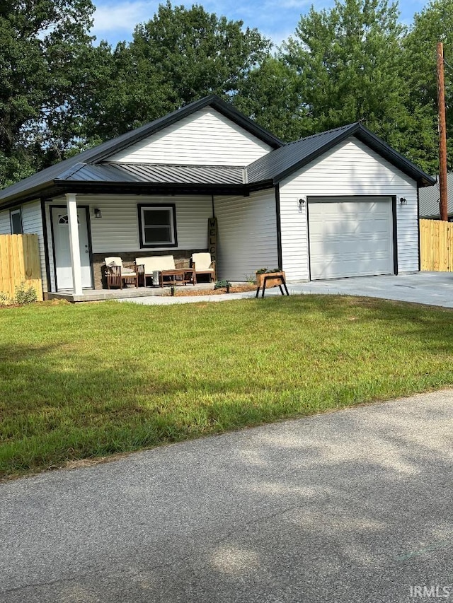 148 SW 8th St, Linton, IN 47441 - ranch-style home with a garage, driveway, a metal roof, and a porch