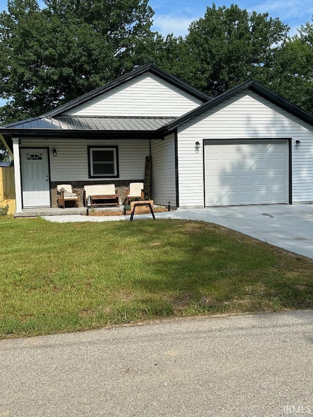 148 SW 8th St, Linton, IN 47441 - view of front facade featuring a front lawn, concrete driveway, a porch, and a garage