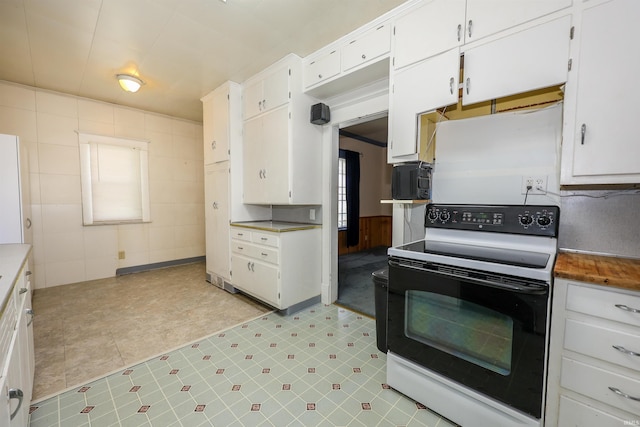 617 S Indiana Ave, Auburn, IN 46706 - kitchen with white range with electric stovetop, white cabinetry, and light countertops
