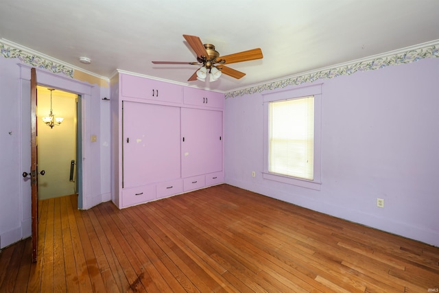 617 S Indiana Ave, Auburn, IN 46706 - unfurnished bedroom with light wood-type flooring, a closet, crown molding, and a ceiling fan