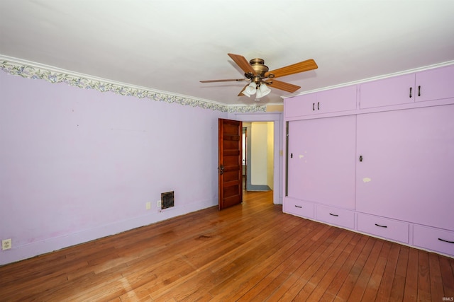 617 S Indiana Ave, Auburn, IN 46706 - unfurnished bedroom featuring light wood-style flooring, a closet, ornamental molding, and ceiling fan