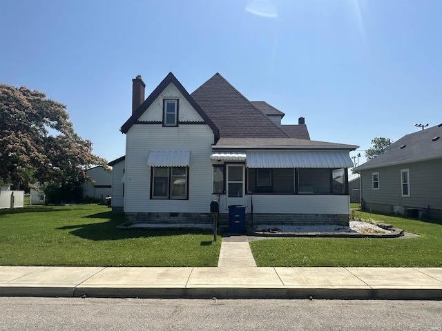 448 N 7th St, Mitchell, IN 47446 - view of front of house with a front yard, a chimney, and a shingled roof