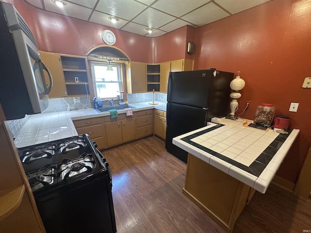 448 N 7th St, Mitchell, IN 47446 - kitchen with black appliances, tile counters, a drop ceiling, dark wood-style flooring, and open shelves